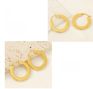 Detail showing the hammered texture and polished gold finish of thick hoop earrings