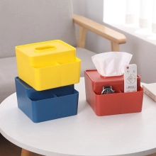 Macro view of colorful plastic tissue boxes with remote control storage on a table