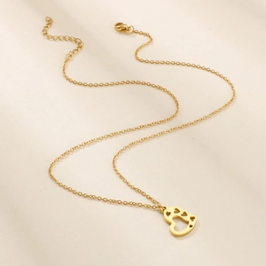 Golden stainless steel necklace featuring a hollow heart pendant with paw print patterns