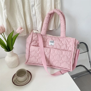 Pink heart-quilted tote bag featuring Cloud Hugger label and adjustable strap detail