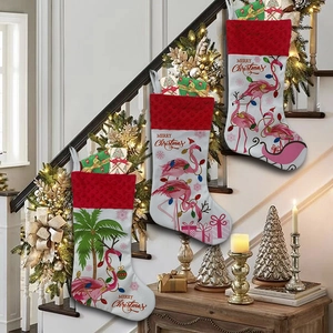 Three festive Christmas stockings with flamingo prints hanging on a decorated staircase