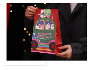 Close-up of red and green Christmas gift bags with cartoon patterns and festive lettering