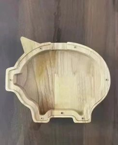 Detail of wooden pig money box showing smooth rubber wood grain and screw holes