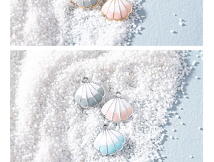 Macro detail of alloy seashell charms with colorful drip oil finish and metal borders