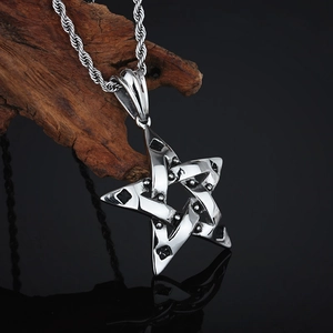 Macro shot of silver stainless steel star pendant on rope chain against wood backdrop