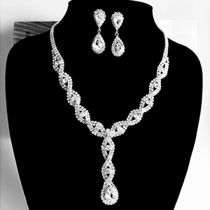 Detailed view of silver twist jewelry set with teardrop crystals on black mannequin