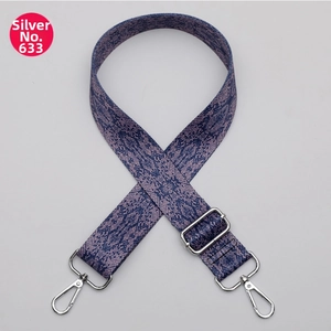 Detail of adjustable crossbody strap with purple python pattern and silver hardware