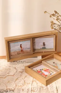 Detail of a rotating double-sided wooden photo frame with natural wood grain finish
