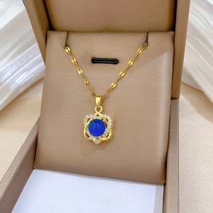 Detail of flower pendant with blue stone and white diamonds in a jewelry box