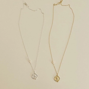 Detail showing gold and silver 925 sterling silver coin necklaces with pearl accents