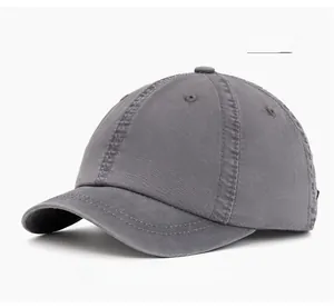 Detailed view of dark gray washed cotton baseball cap with ventilation eyelets and stitching