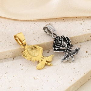 Vue détaillée de pendentifs rose en or et argent sur une pierre beige