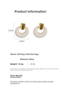 Detail view of white enamel hoop earrings showing dimensions of 2.9cm and product weight
