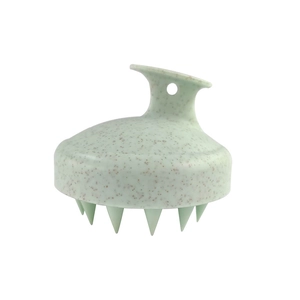 Detail of light green wheat straw scalp massager with ergonomic handle and hanging hole