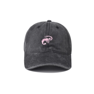 Close-up of pink shrimp embroidery on washed vintage black cotton baseball cap