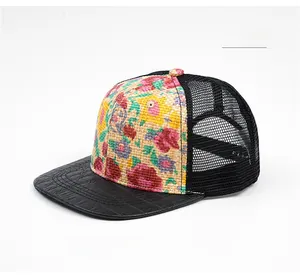 Detail of floral straw front panel and crocodile textured brim on a trucker hat