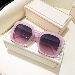 Detailed close-up of pink glitter square sunglasses frame with gradient purple lenses