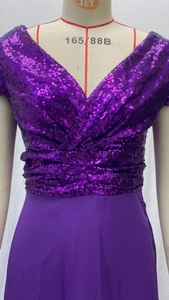 Detail of purple sequin bodice with V-neckline and ruched waist on evening dress