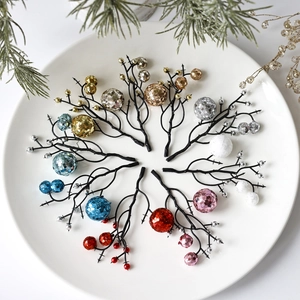 Glittery Christmas berry stems in multiple colors arranged on a white plate with pine needles