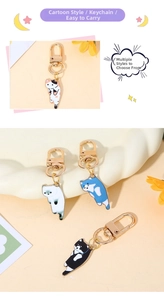 Detail of cute enamel cartoon cat keychains in white, blue, and calico with gold lobster clasps