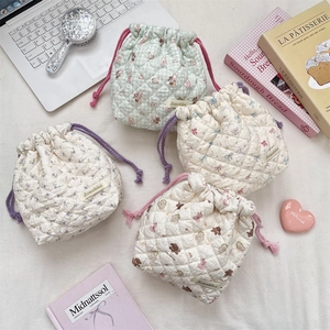 Quilted drawstring storage bags with cartoon bear and floral patterns for travel