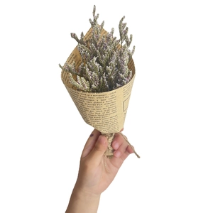 Mini dried flower bouquet wrapped in vintage newspaper with twine for gift decoration