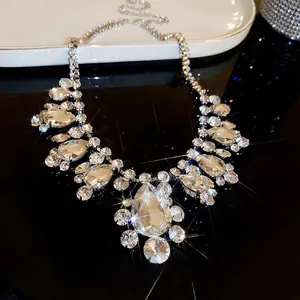 Luxury statement necklace with round teardrop crystals on a reflective black surface