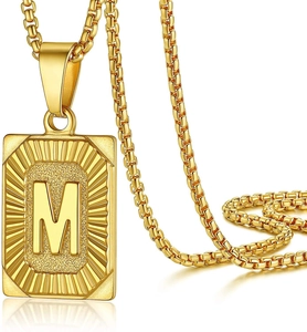Gold plated box chain necklace with a rectangular letter M pendant featuring radial textures
