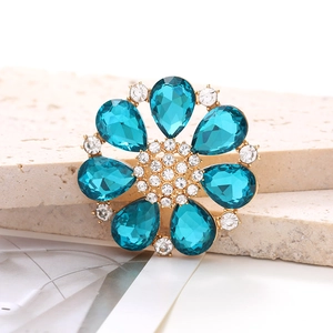 Macro detail of alloy flower shoe charm with peacock blue pear-shaped rhinestones
