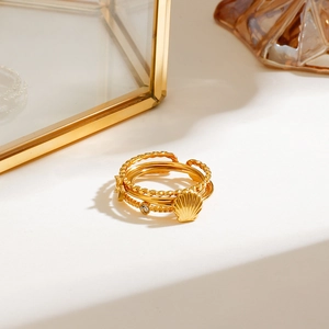 Detail shot of multi-layer gold plated rings with shell and star elements on display