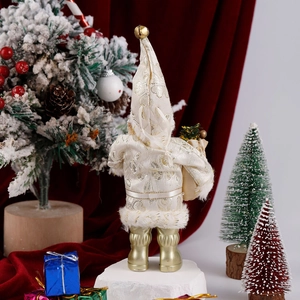 Rear view of standing Santa plush in white and gold fabric with a festive holiday backdrop