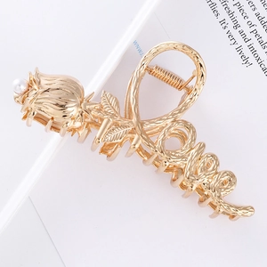Golden tulip and love script hair claw clip with pearl accent on white background