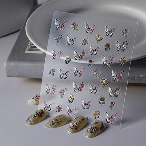 Macro view of 5D embossed nail art stickers with butterfly and floral patterns style 487