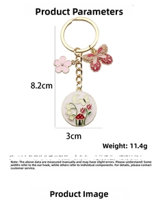 Detailed view of pink flower and butterfly pendant keychain showing 8.2cm total length