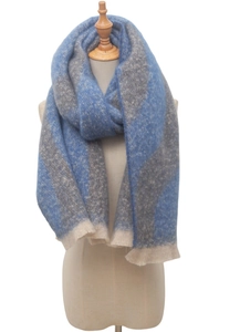 Close-up of blue and beige bouclé yarn scarf showing soft jacquard texture and fringed edges