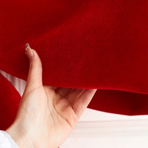 Large red velvet Christmas bow featuring soft texture and elegant drape for tree decor