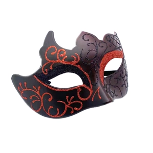 Detail of red glitter pattern on black masquerade mask for men at parties