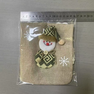 Christmas burlap wine bag with green decor measuring 14cm width on a grey table