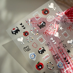 Christmas nail art stickers featuring cute black cats, snowmen, and red apples with silver foil