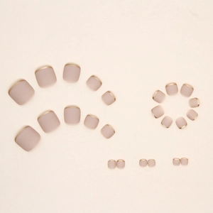 Matte nude pink french toe nail tips with gold metallic edges in various sizes set