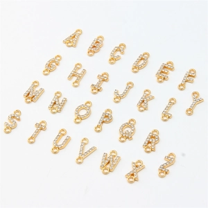 Macro detail of complete A-Z alphabet and number alloy charms with sparkling rhinestones