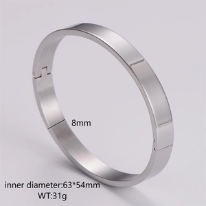 Polished silver stainless steel bangle detail showing 8mm width and 63x54mm inner diameter