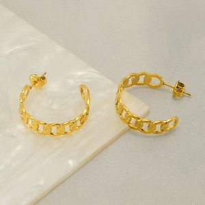 Golden C-shaped stainless steel chain link earrings with high polish on marble surface