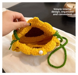 Detail view of sunflower crochet bag interior with pearl clasp and green woven strap