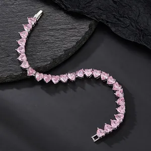 Pink heart zircon tennis bracelet in silver finish with fold-over clasp on black stone