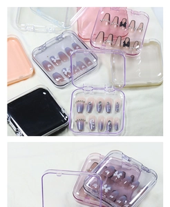 Detailed view of square colorful plastic storage boxes for press-on nails with clear lids