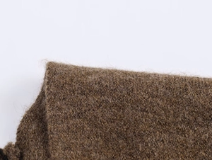 Close-up of the plush brown knit fabric showing the thick, fluffy mohair wool texture