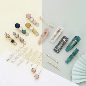 Flat lay of colorful acetate hair clips set with pearl and marble texture details