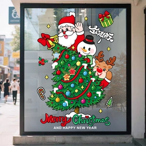 Close-up of Santa Claus and snowman static window stickers on a glass storefront