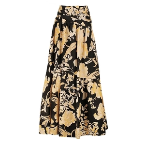 Detail of high-waist maxi skirt with retro floral print and elegant bohemian A-line silhouette